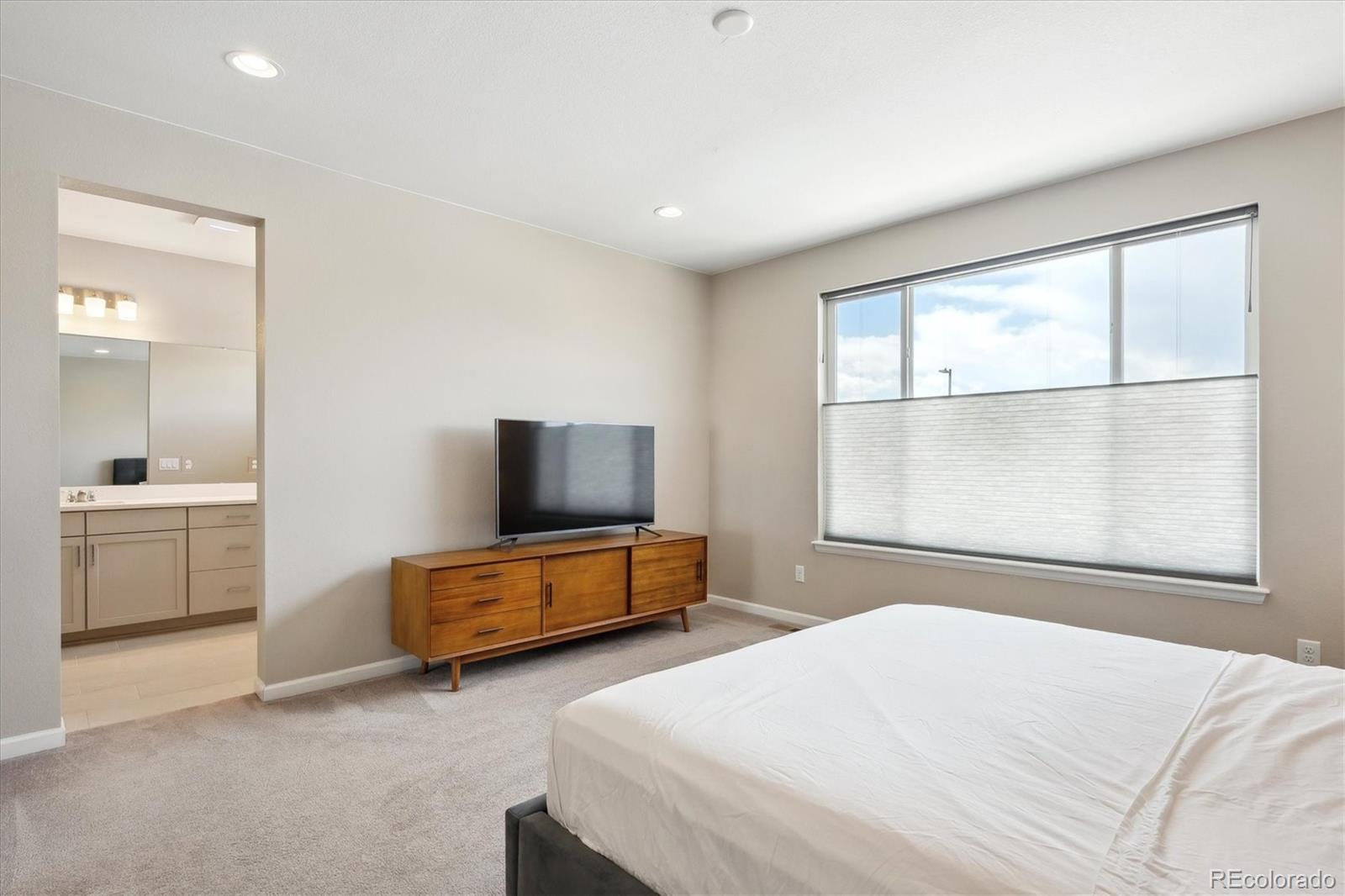 10557 Eby Circle Lone Tree, CO 80124 - Photo 30 of 50 a bedroom with furniture and a flat screen tv