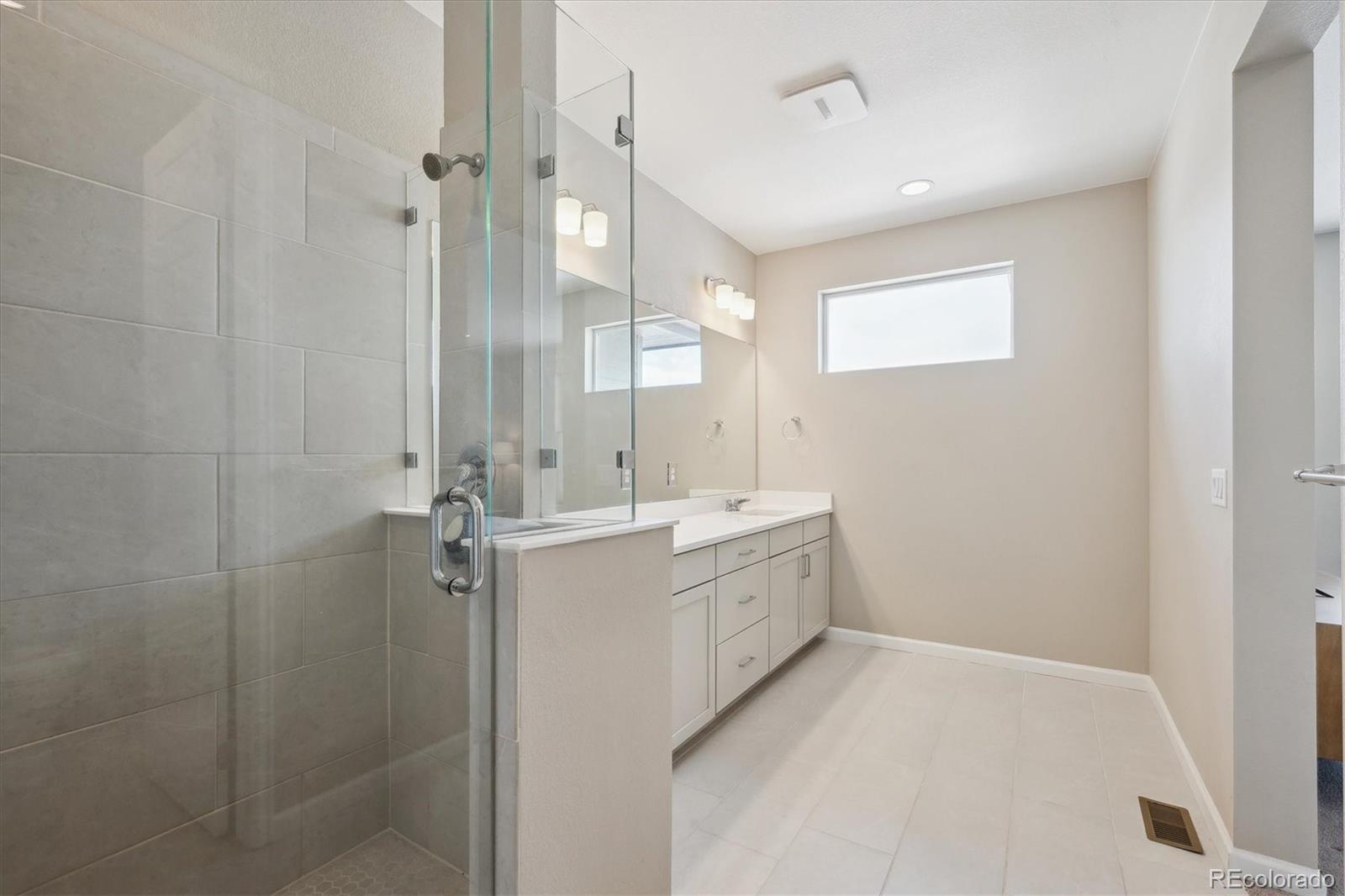 10557 Eby Circle Lone Tree, CO 80124 - Photo 33 of 50 a bathroom with a sink a toilet and shower