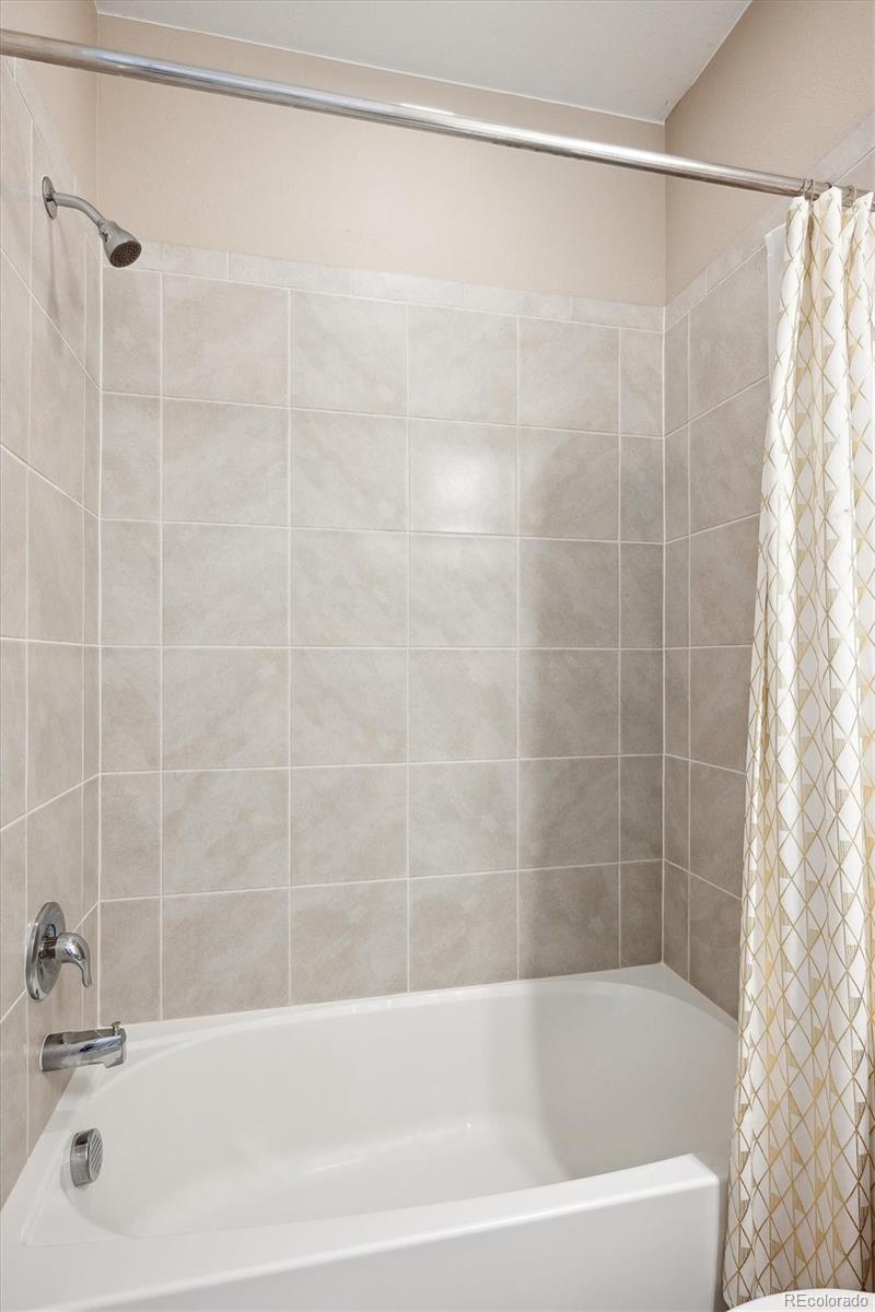 10557 Eby Circle Lone Tree, CO 80124 - Photo 42 of 50 a bathroom with a shower and a bath tub
