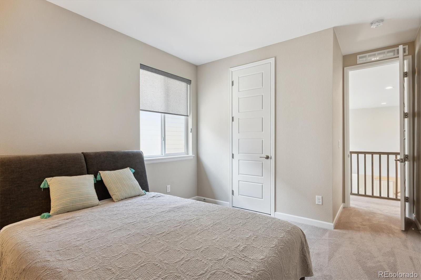 10557 Eby Circle Lone Tree, CO 80124 - Photo 44 of 50 a bedroom with a bed and a window