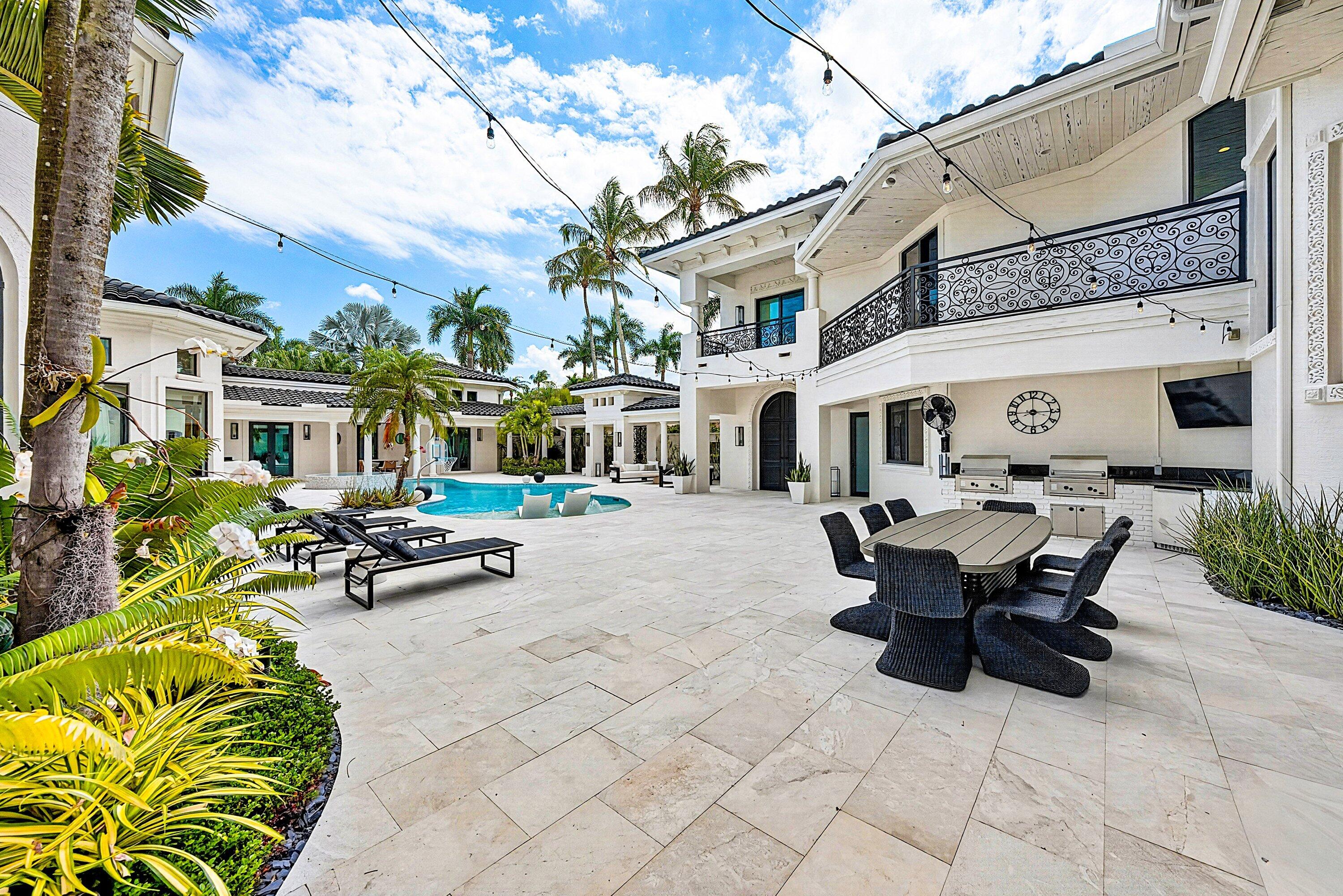 3633 Carlton Place Boca Raton, FL 33496 - Photo 13 of 99 a view of a patio with table and chairs potted plants and a large tree