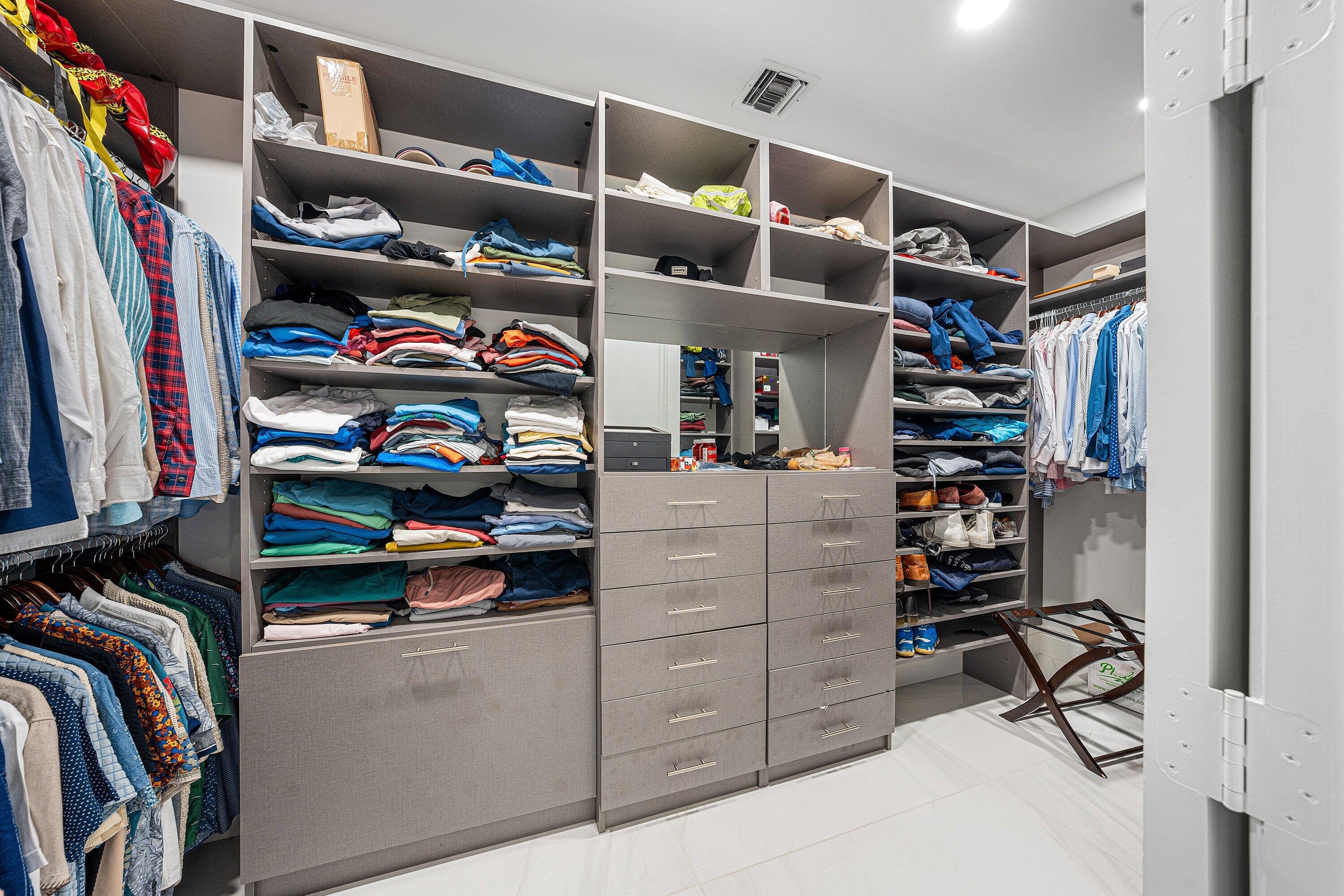 3633 Carlton Place Boca Raton, FL 33496 - Photo 44 of 99 a view of walk in closet with clothes and shoes