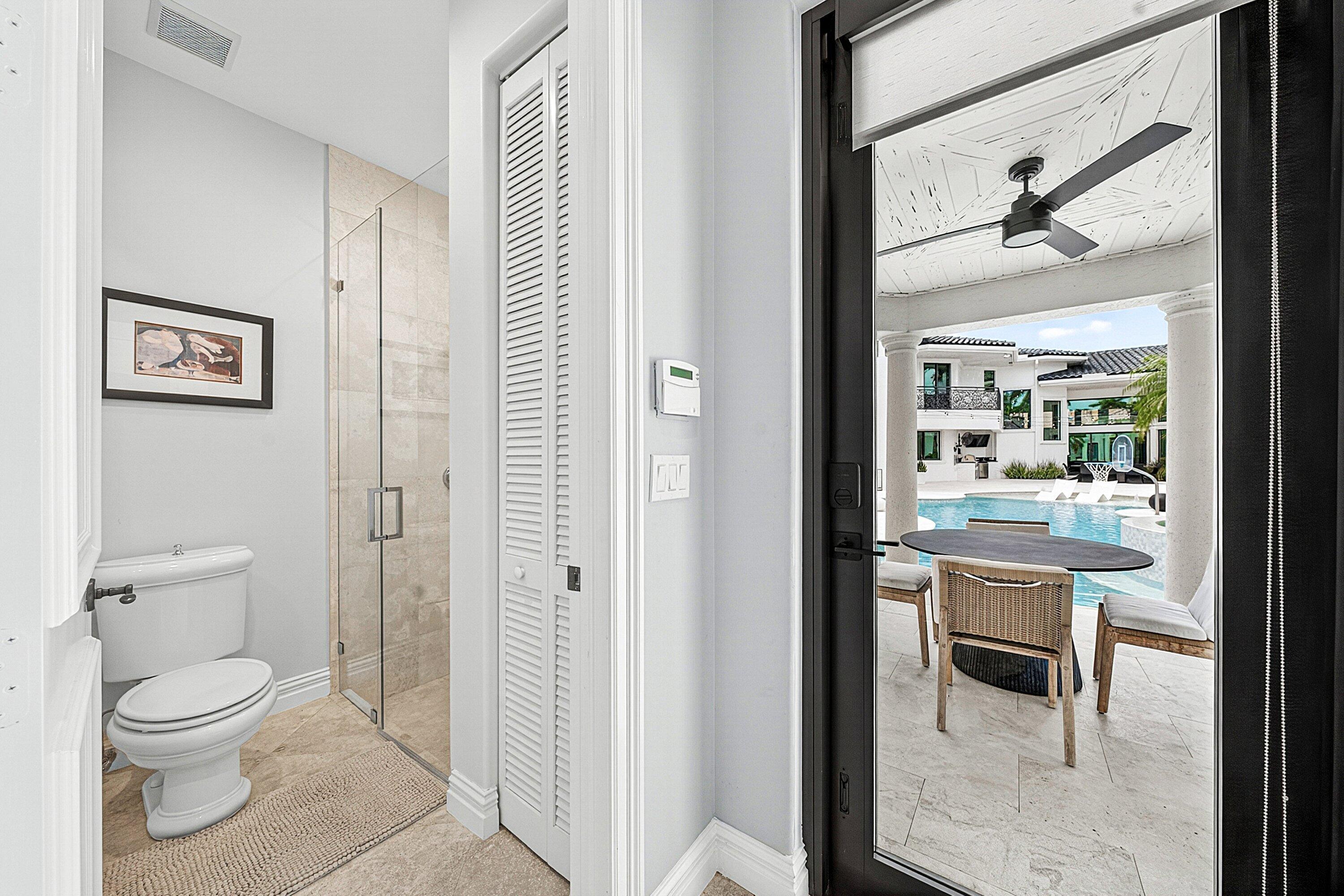 3633 Carlton Place Boca Raton, FL 33496 - Photo 72 of 99 a bathroom with a toilet a sink and a large mirror