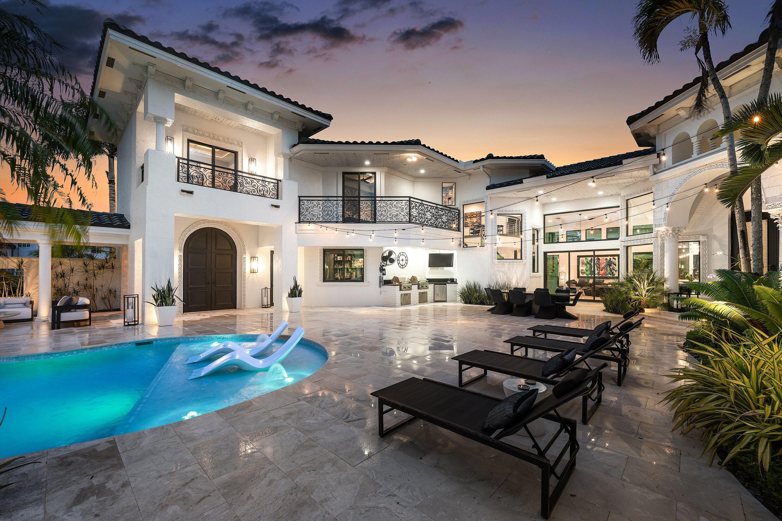 3633 Carlton Place Boca Raton, FL 33496 - Photo 98 of 99 a front view of a house with patio furniture and a fireplace