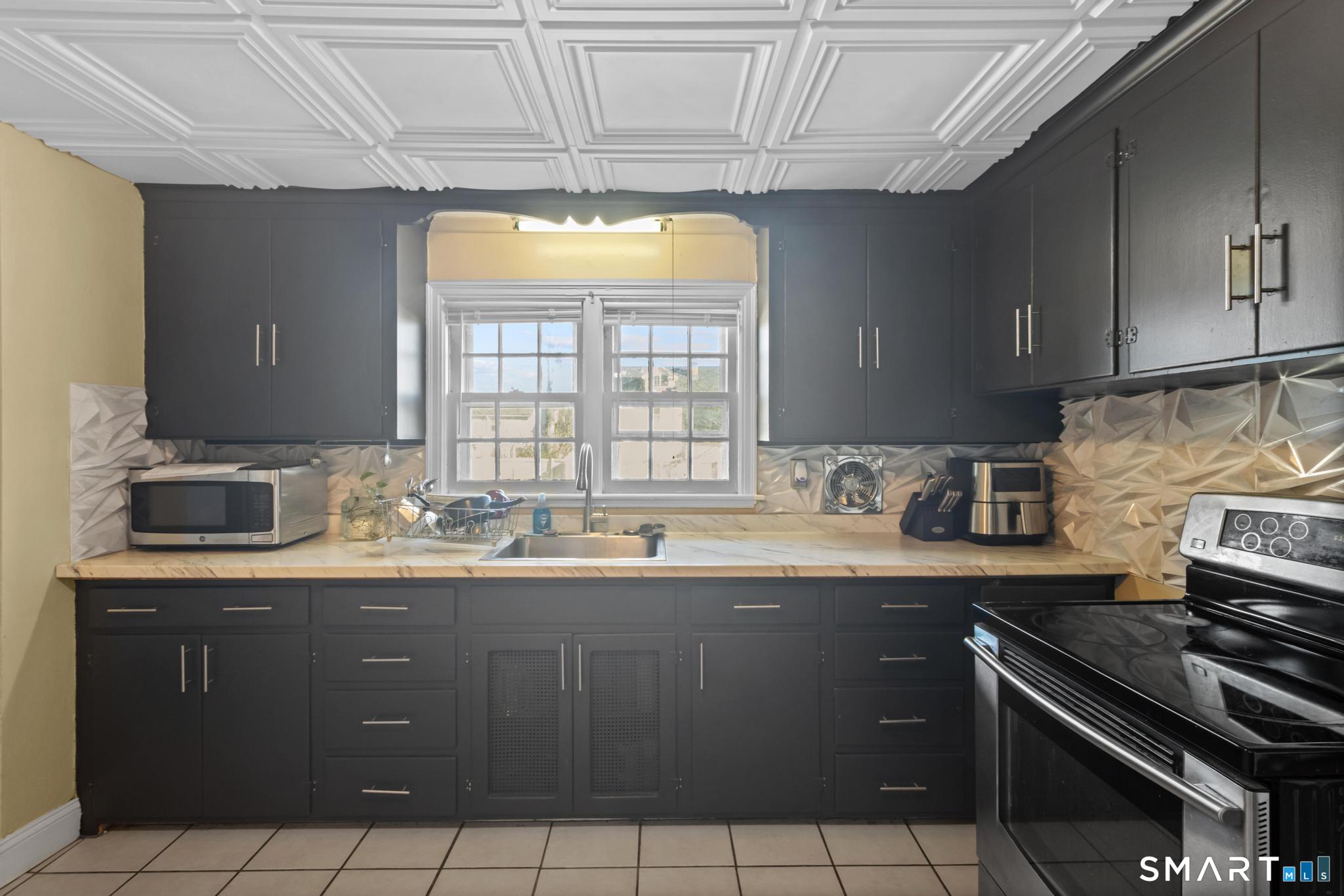 168 Hubbard Road Hartford, CT 06114 - Photo 11 of 27 a kitchen with granite countertop a sink a stove and cabinets