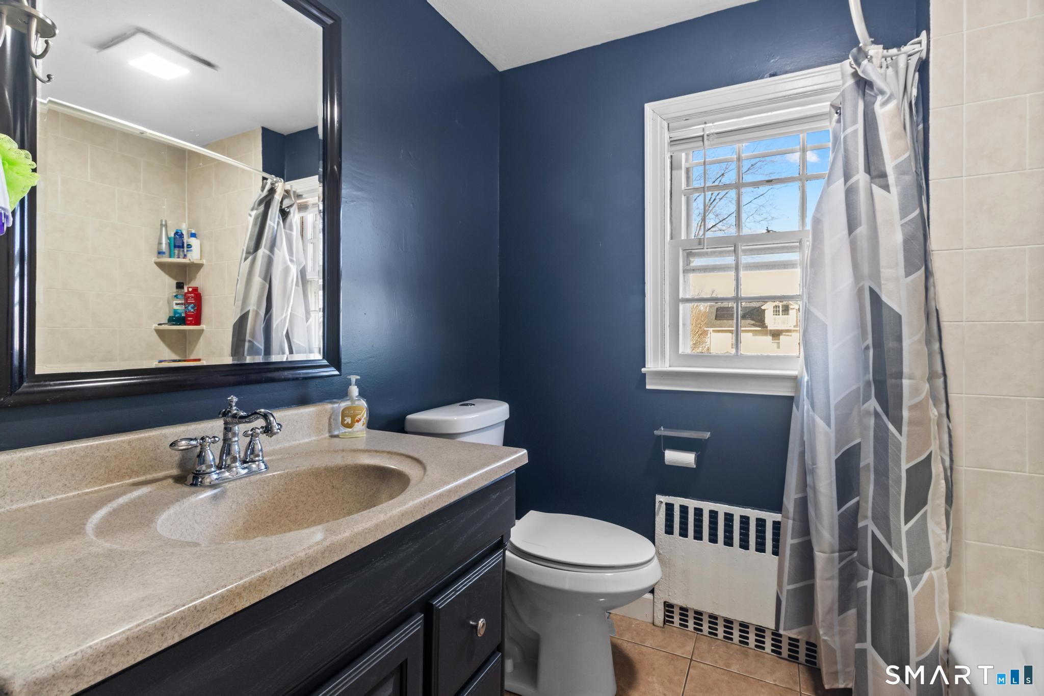 168 Hubbard Road Hartford, CT 06114 - Photo 23 of 27 a bathroom with a sink toilet and a mirror