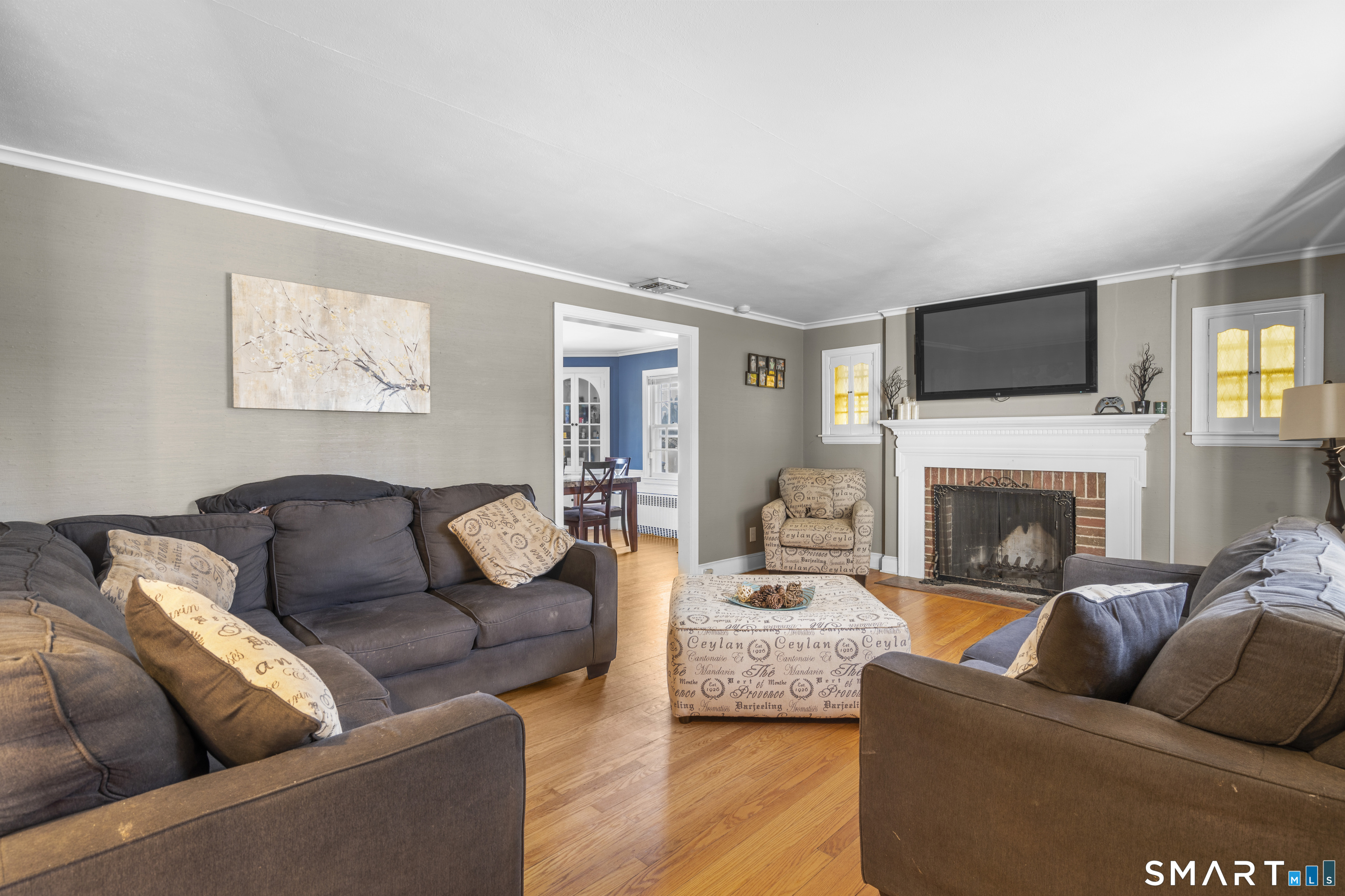 168 Hubbard Road Hartford, CT 06114 - Photo 3 of 27 a living room with furniture a flat screen tv and a fireplace