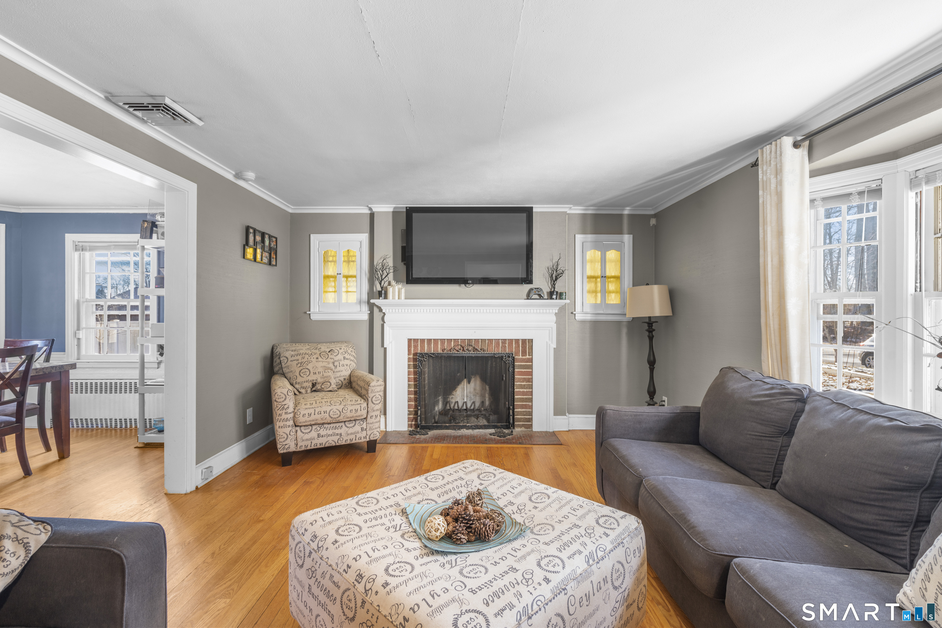 168 Hubbard Road Hartford, CT 06114 - Photo 4 of 27 a living room with furniture a flat screen tv and a fireplace