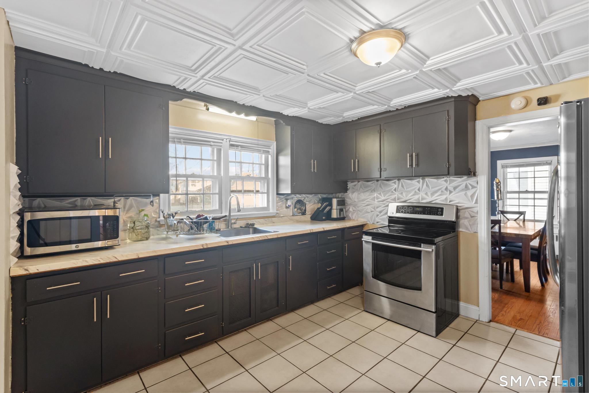 168 Hubbard Road Hartford, CT 06114 - Photo 9 of 27 a kitchen with a sink stove and cabinets