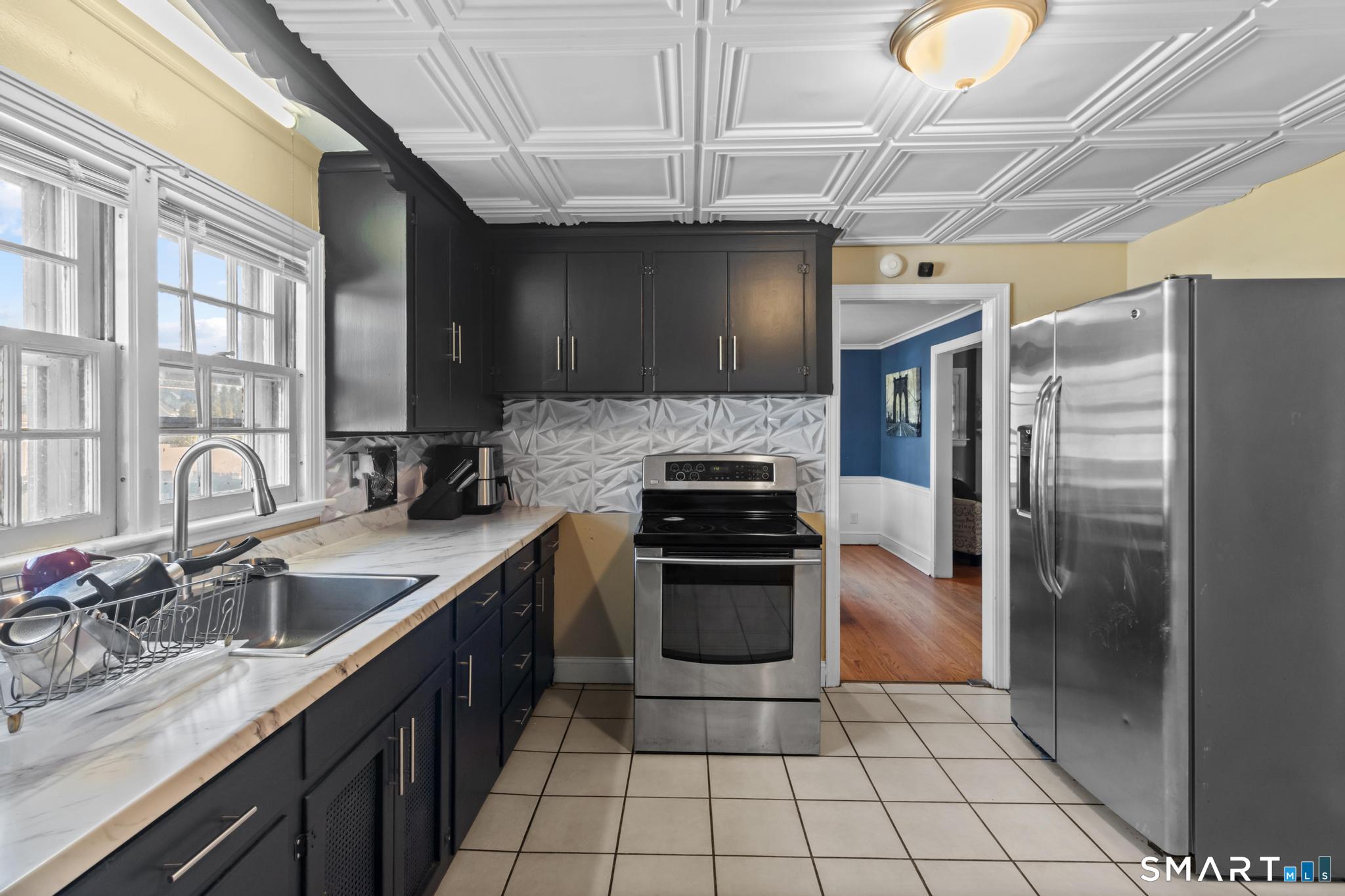 168 Hubbard Road Hartford, CT 06114 - Photo 10 of 27 a kitchen with stainless steel appliances granite countertop a sink stove and refrigerator