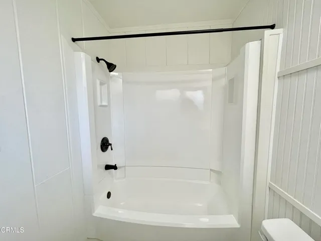 a kitchen with white cabinets and a sink