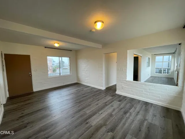 a view of an empty room and wooden floor
