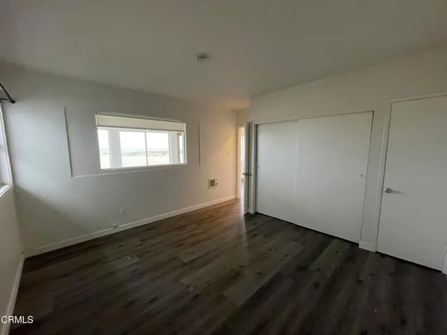 a view of hallway with wooden floor
