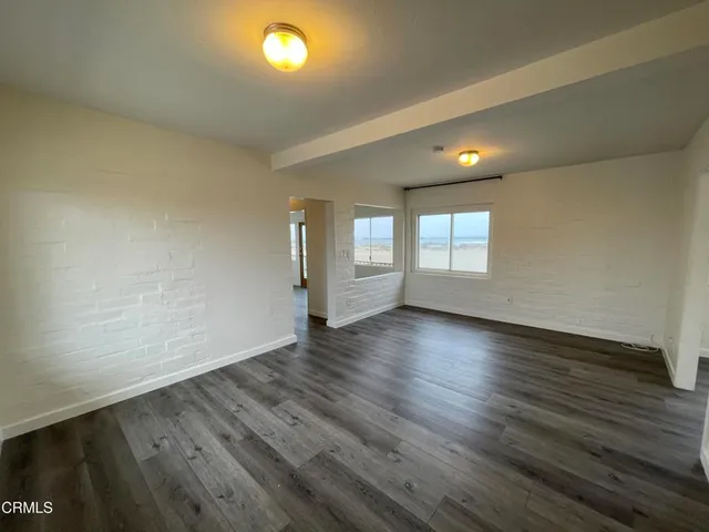 a view of hallway with wooden floor and stairs