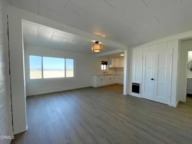 a kitchen with granite countertop a refrigerator and a sink
