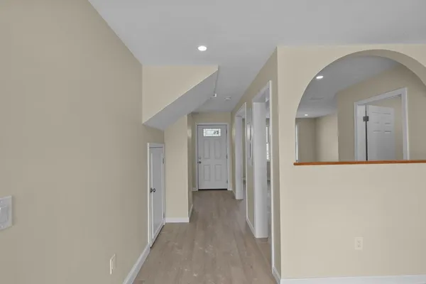 a view of a hallway with wooden floor