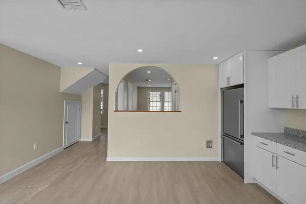 a view of a kitchen with a sink and dishwasher a refrigerator with wooden floor