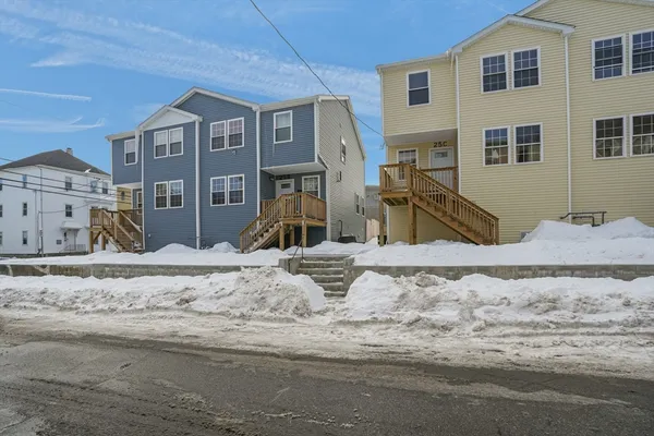a view of a house with snow on the road
