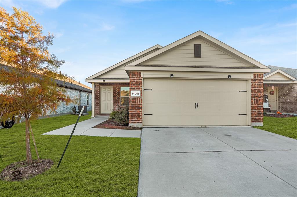 14048 Earlham Street Pilot Point, TX 76258 - Photo 1 of 15 a front view of a house with a yard