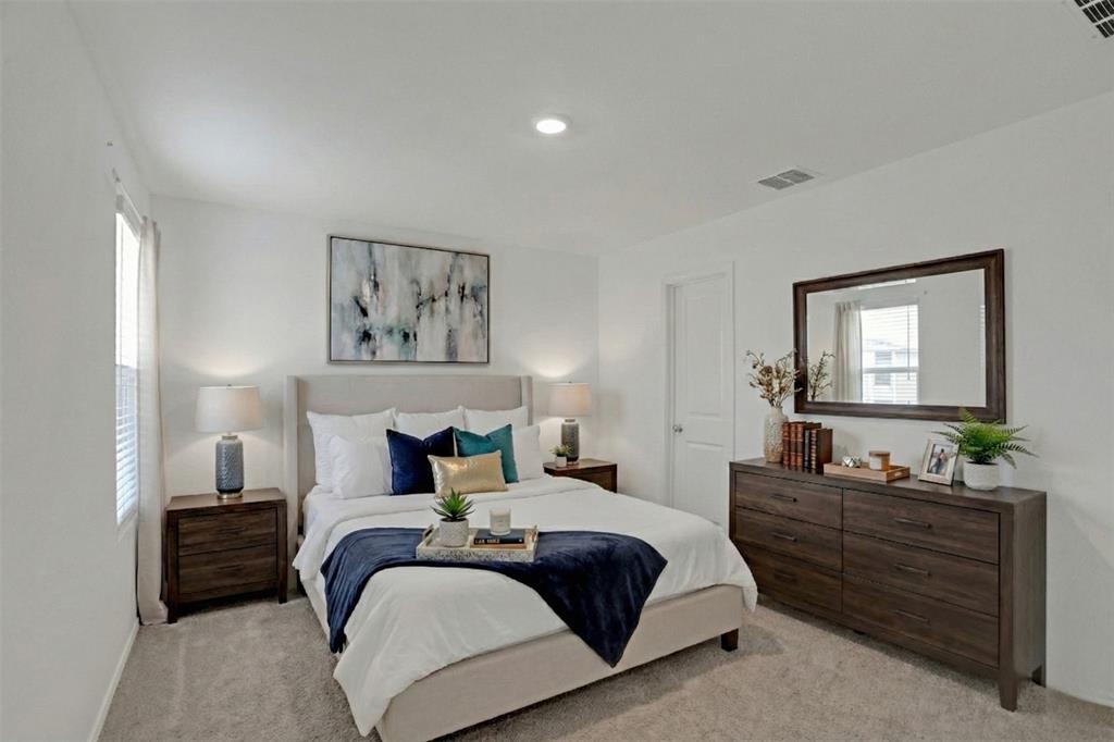 14048 Earlham Street Pilot Point, TX 76258 - Photo 7 of 15 a bedroom with a bed and a mirror