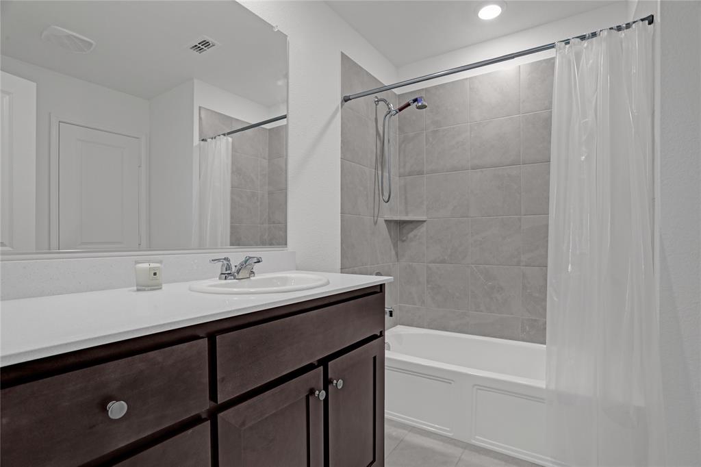 14048 Earlham Street Pilot Point, TX 76258 - Photo 8 of 15 a bathroom with a sink and a mirror
