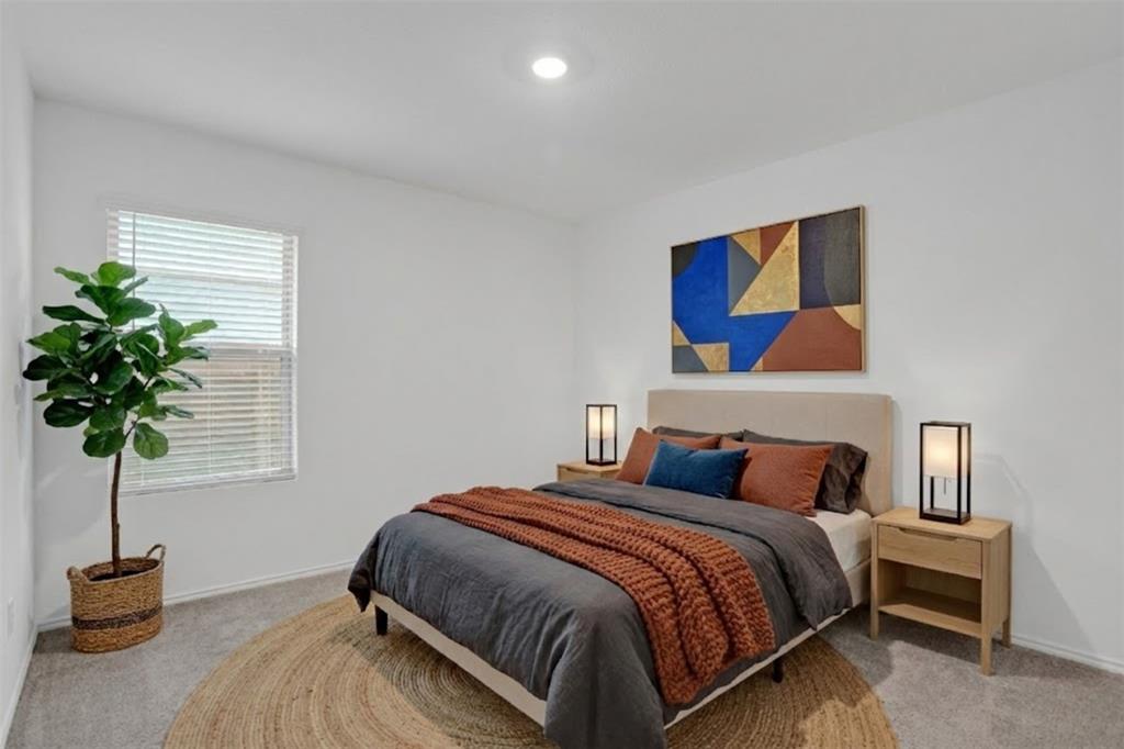 14048 Earlham Street Pilot Point, TX 76258 - Photo 9 of 15 a bedroom with a bed and a potted plant