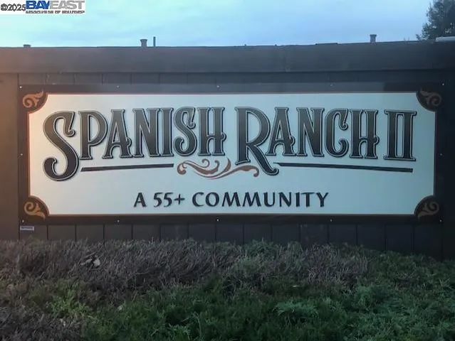 a view of pool with table and chairs under an umbrella