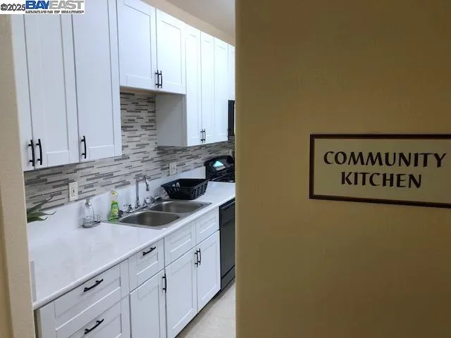 a kitchen with stainless steel appliances a stove microwave and sink