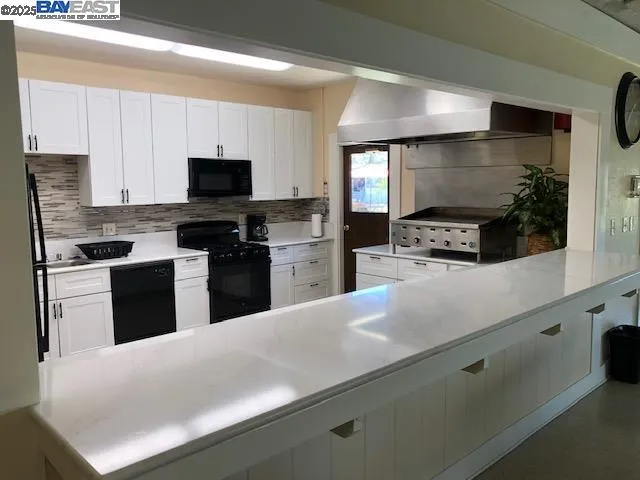 a view of a livingroom with furniture wooden floor and a fireplace