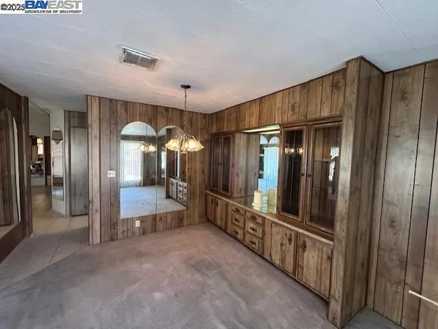 a kitchen with a sink a refrigerator and cabinets