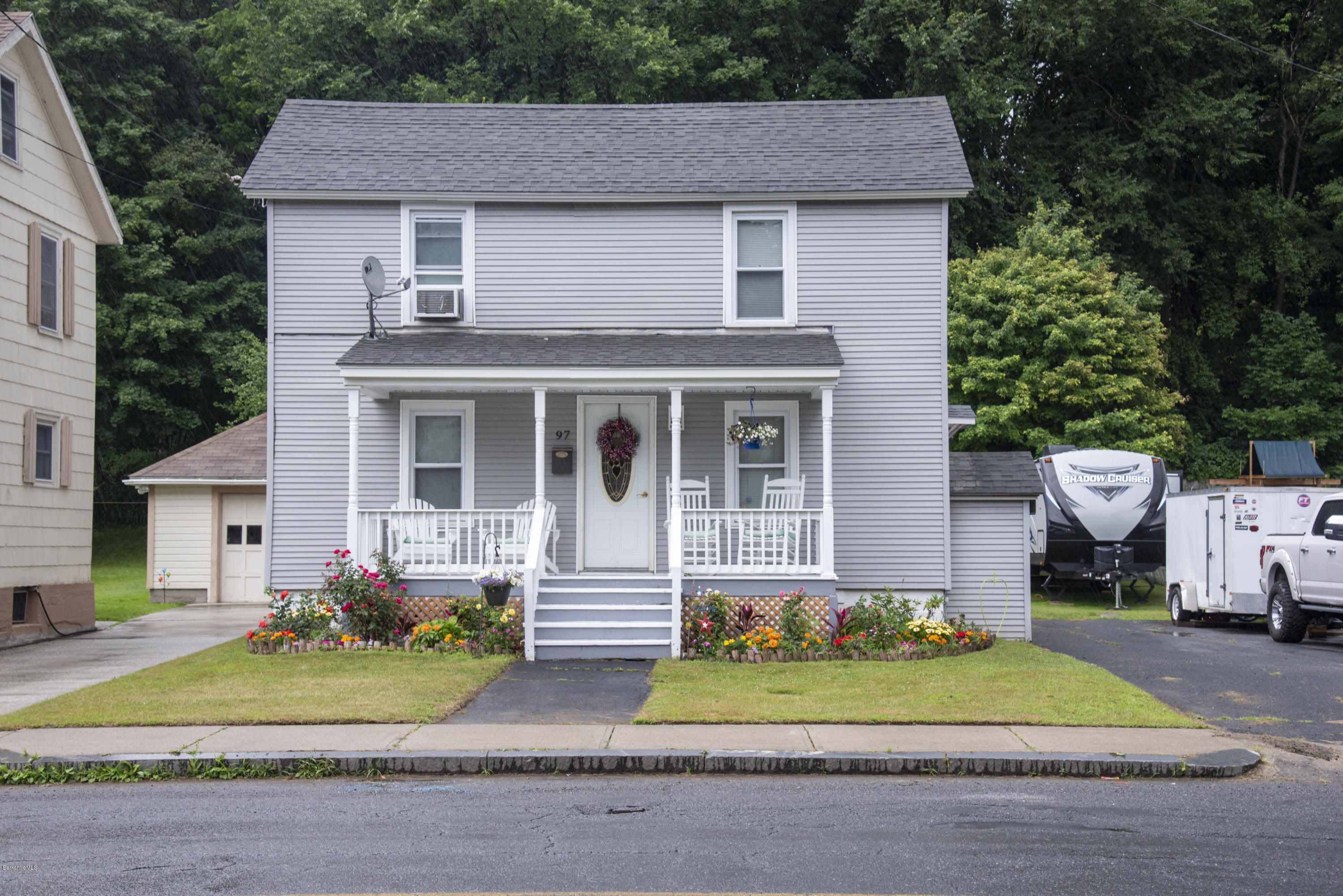 97 North Summer Street Adams, MA 01220 - Photo 2 of 17 a front view of a house with a garden and plants