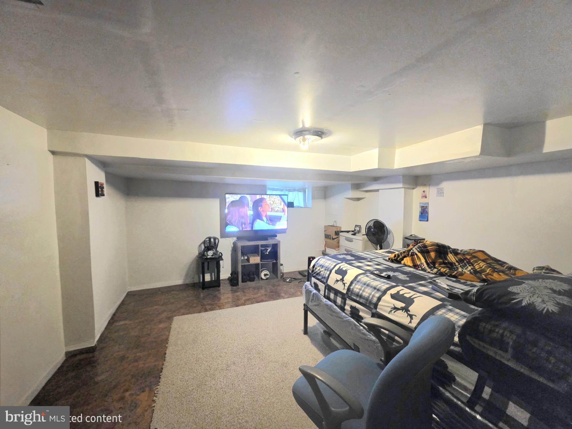 2730 East Chase Street Baltimore, MD 21213 - Photo 13 of 17 a bed room with furniture and a flat screen tv