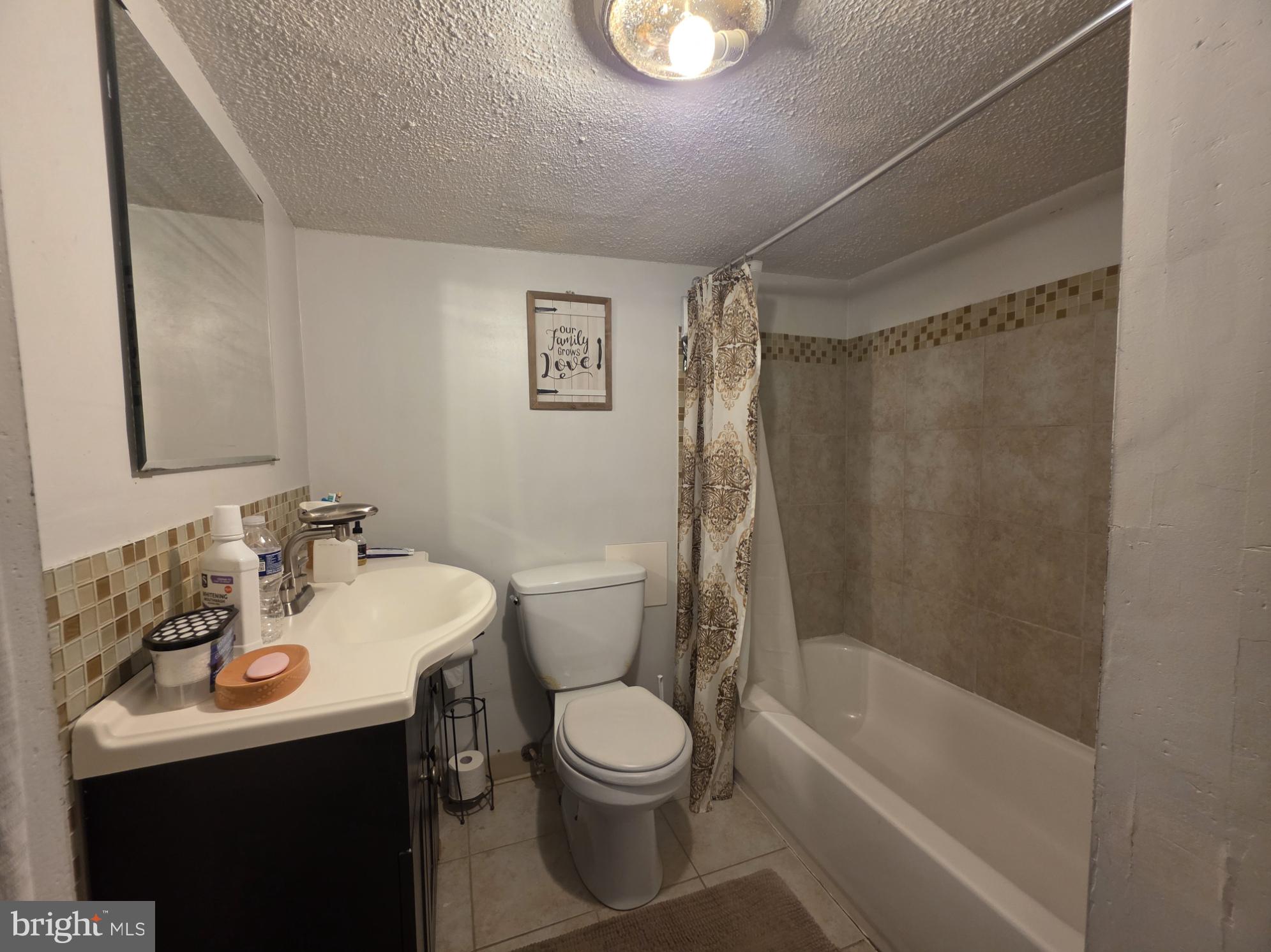2730 East Chase Street Baltimore, MD 21213 - Photo 15 of 17 a bathroom with a sink toilet and shower