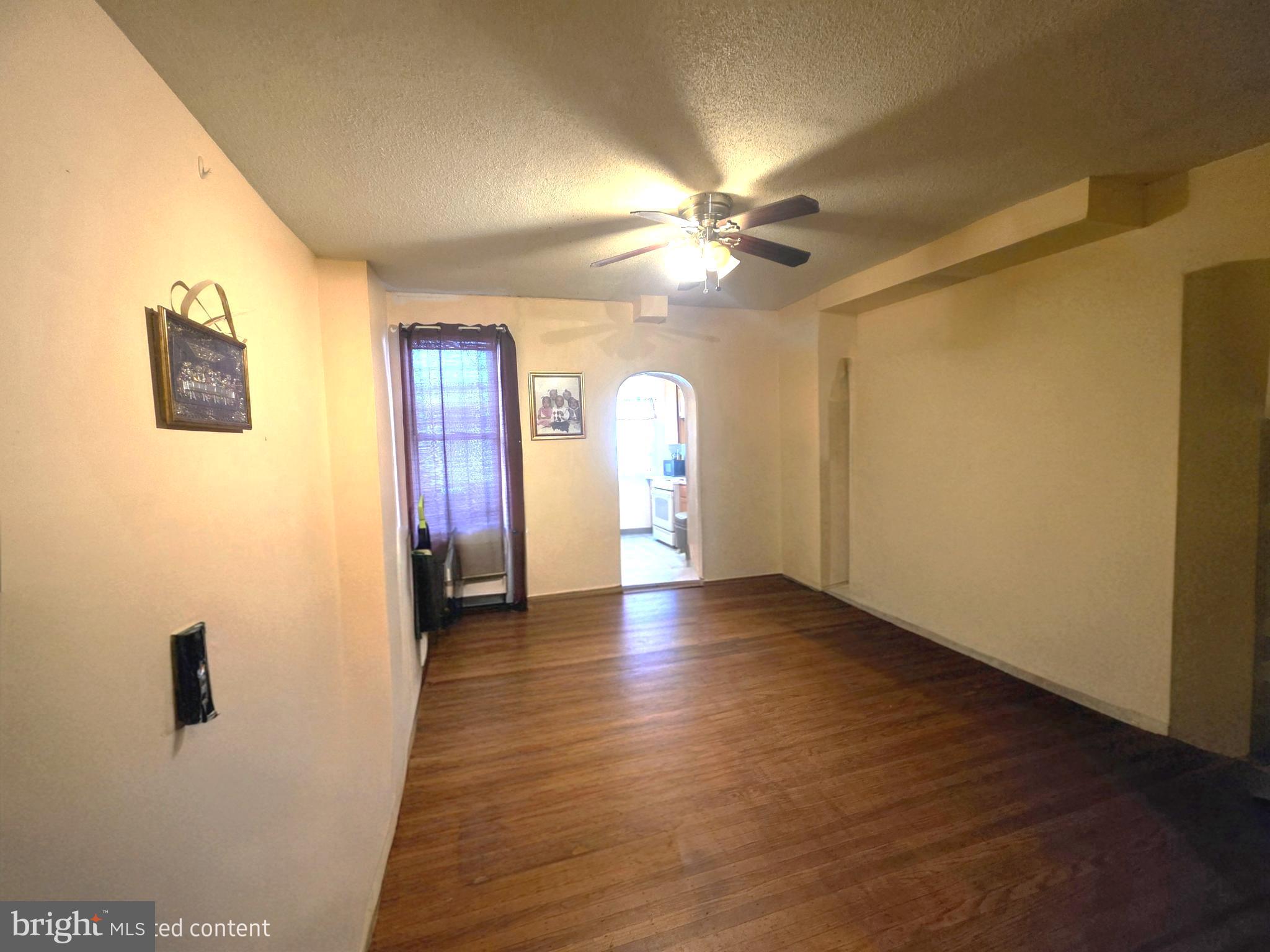 2730 East Chase Street Baltimore, MD 21213 - Photo 2 of 17 a view of empty room with wooden floor