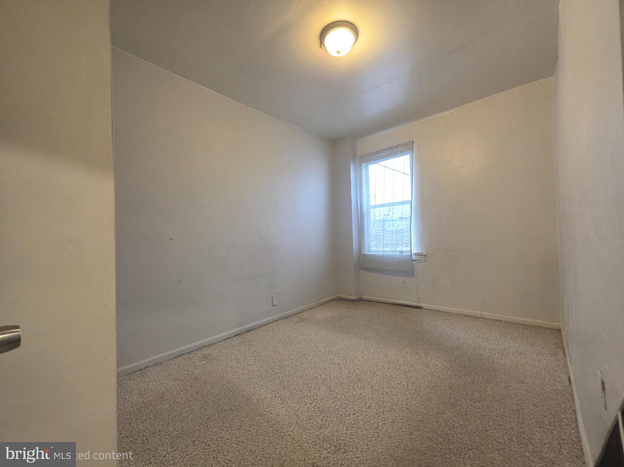 2730 East Chase Street Baltimore, MD 21213 - Photo 6 of 17 an empty room with windows