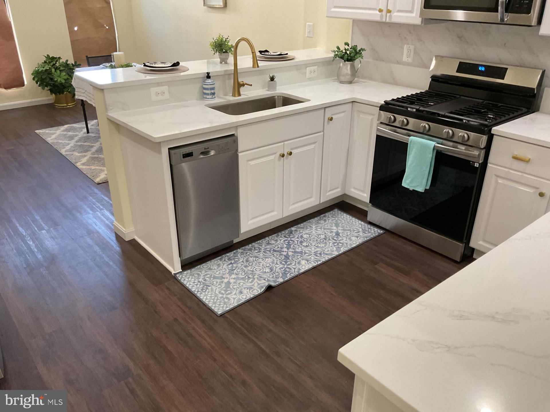 a kitchen with a sink stove and cabinets