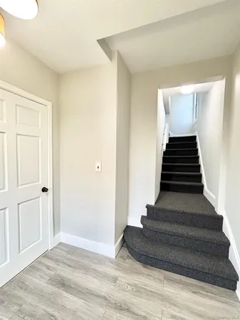 a view of entryway and hall with wooden floor