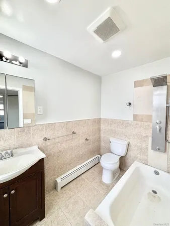 a bathroom with a sink a toilet and bathtub