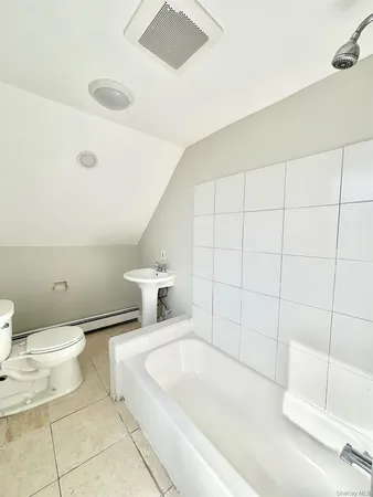 a bathroom with a toilet and a bathtub