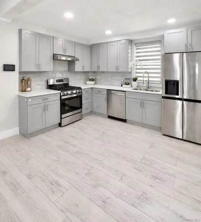a kitchen with stainless steel appliances a refrigerator sink and cabinets