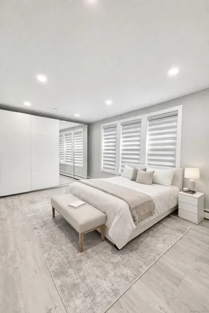 a spacious bedroom with a bed and window
