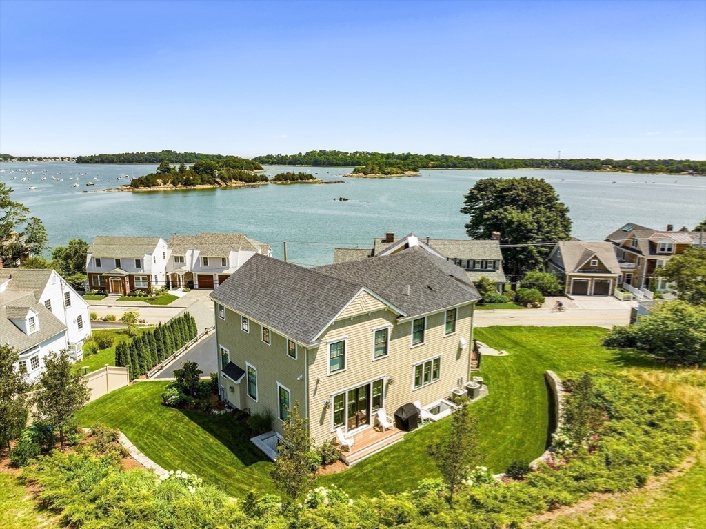 a aerial view of a house with a garden and lake view