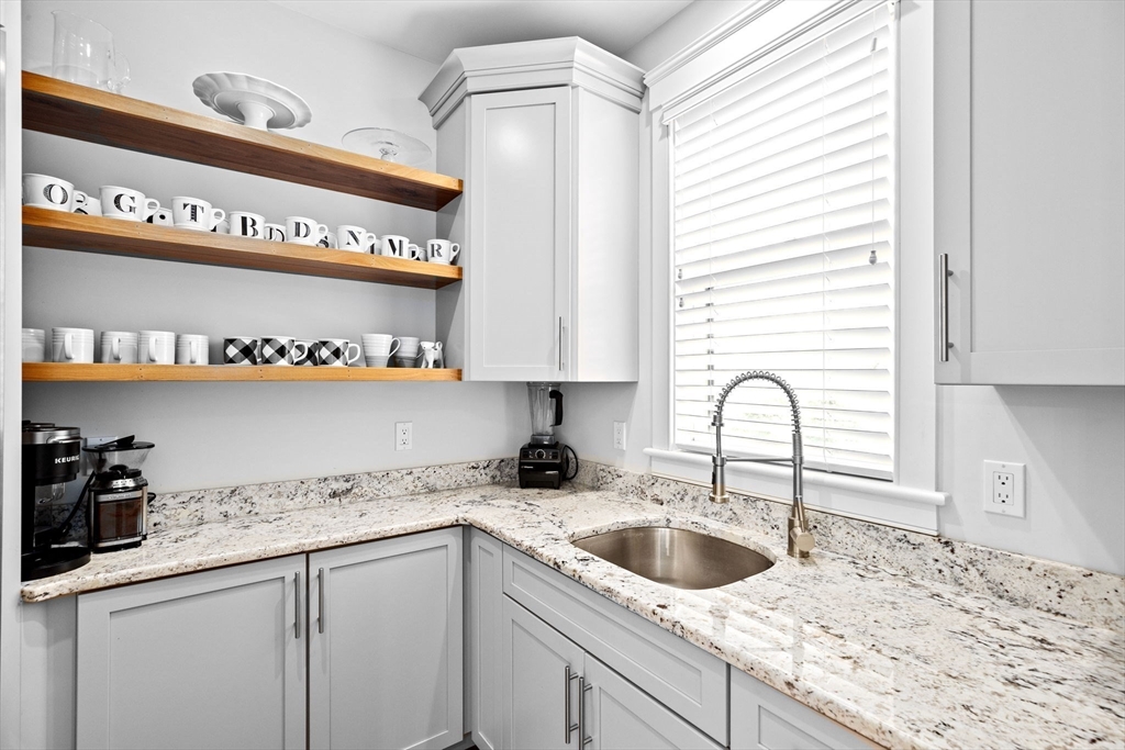 170 Otis Street Hingham, MA 02043 - Photo 13 of 42 a kitchen with stainless steel appliances granite countertop a sink a stove and cabinets