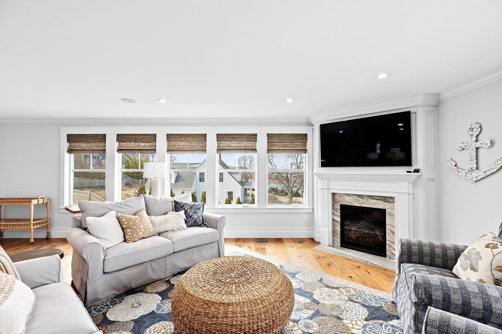170 Otis Street Hingham, MA 02043 - Photo 17 of 42 a living room with furniture a fireplace and a flat screen tv