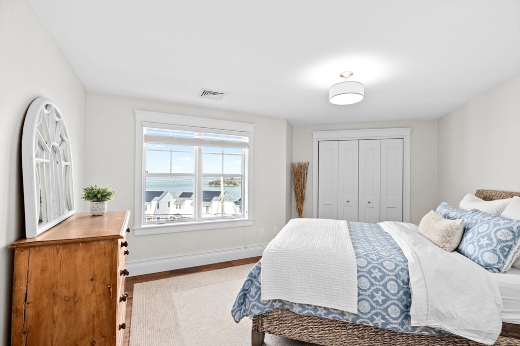 170 Otis Street Hingham, MA 02043 - Photo 24 of 42 a bedroom with a large bed and a large window