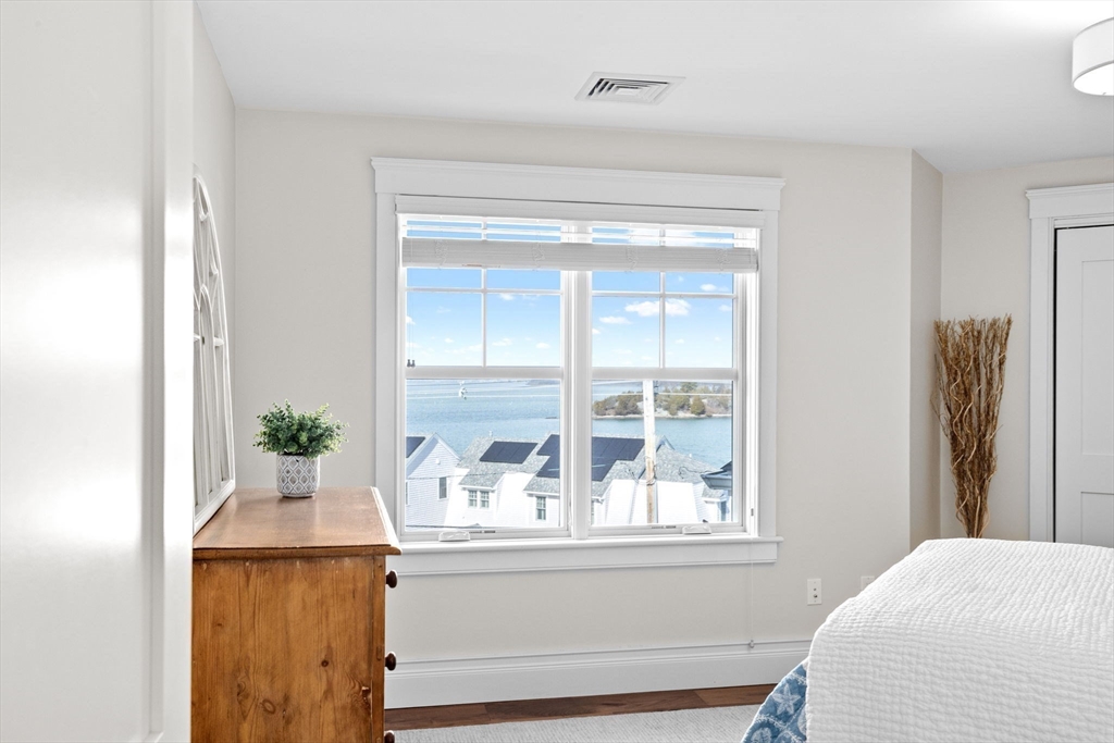 170 Otis Street Hingham, MA 02043 - Photo 25 of 42 a living room with a bed and a window