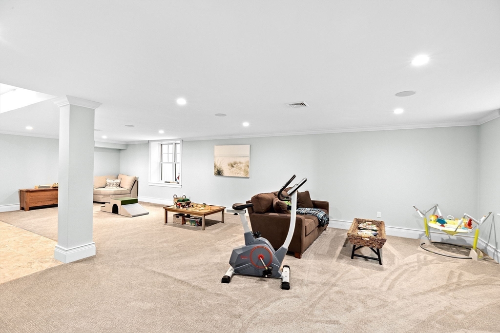 170 Otis Street Hingham, MA 02043 - Photo 30 of 42 a living room with furniture and a gym machine