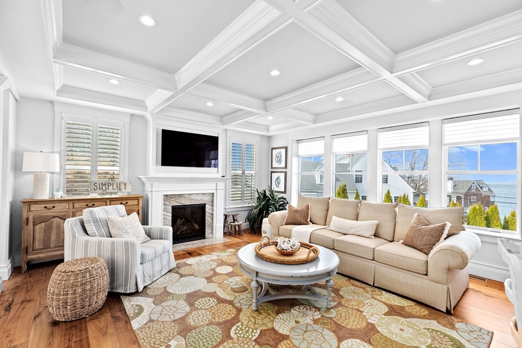 170 Otis Street Hingham, MA 02043 - Photo 3 of 42 a living room with furniture a fireplace and a large window