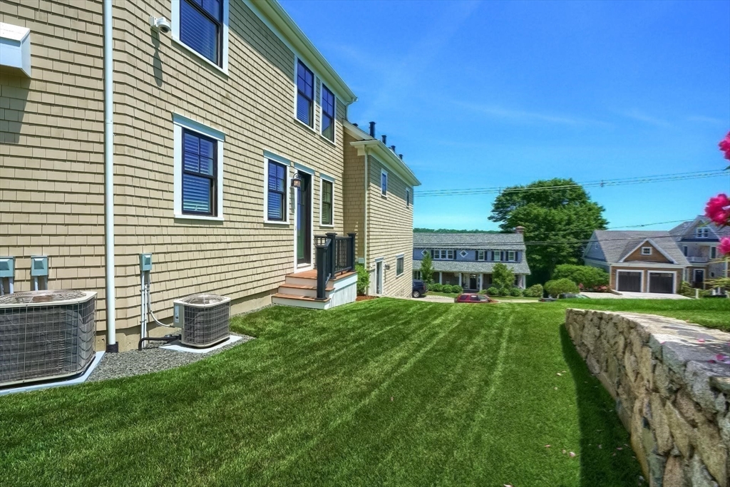 170 Otis Street Hingham, MA 02043 - Photo 37 of 42 a front view of a house with a yard