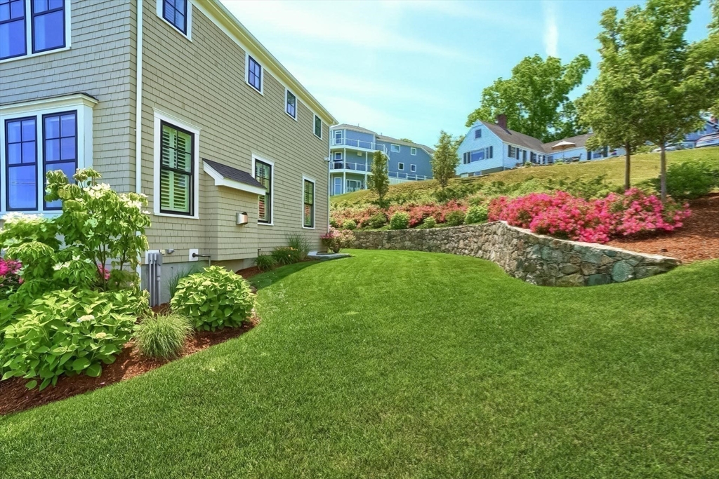 170 Otis Street Hingham, MA 02043 - Photo 40 of 42 a front view of a house with a yard and potted plants